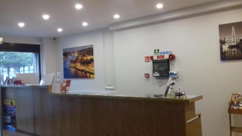 a waiting room with a cash counter in a store at Hotel Paulista in Porto