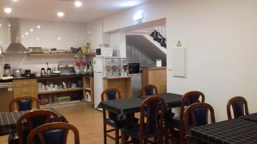 a kitchen that has a table and chairs in it at Hotel Paulista in Porto