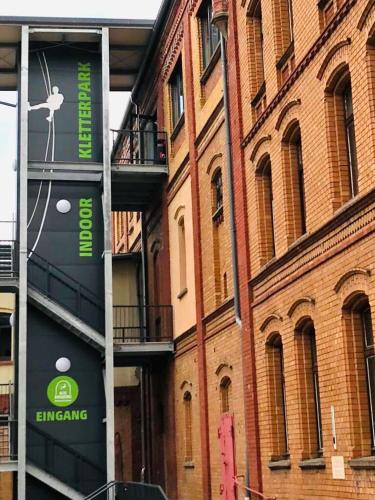a building with green signs on the side of it at Hostel & Pension Alte Brauerei in Eisenach