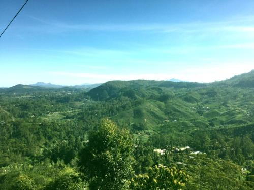 a view of a valley with mountains in the distance at White Home in Haputale