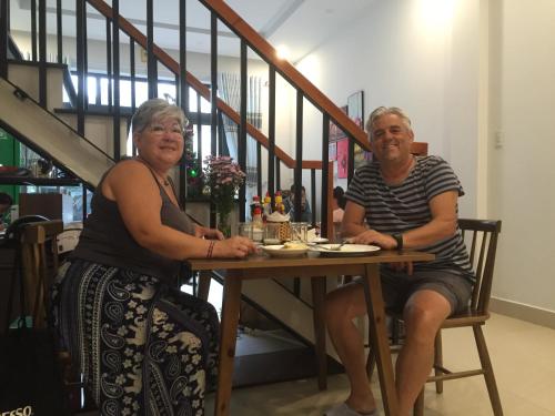 a man and a woman sitting at a table at candyinn in Hue