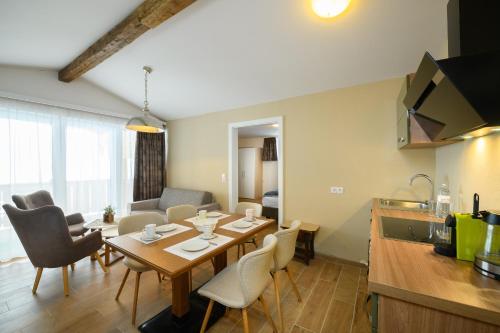 a kitchen and living room with a table and chairs at Landhotel Anna in Sankt Martin am Tennengebirge