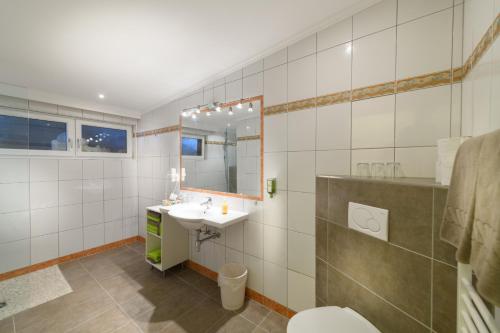 a bathroom with a sink and a toilet and a mirror at Landhotel Anna in Sankt Martin am Tennengebirge