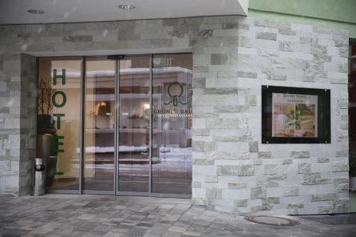 a store front with glass doors on a building at Hotel Grüner Baum in Zell am See
