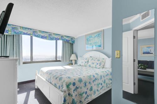 a bedroom with a bed and a window at Sands Beach Club Resort in Myrtle Beach