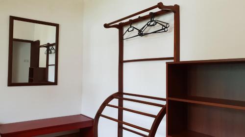 a wooden ladder next to a mirror and a shelf at Emildale Villa in Wadduwa