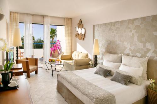 a bedroom with a large bed and a living room at Azia Resort & Spa in Paphos City