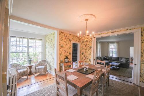 a dining room with a table and a couch at The Gables of Rhinebeck in Rhinebeck