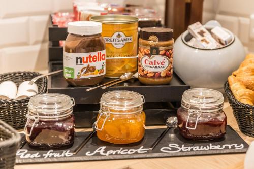 a shelf with jars of honey on it at Holiday Inn - the niu, Cobbles Essen by IHG in Essen