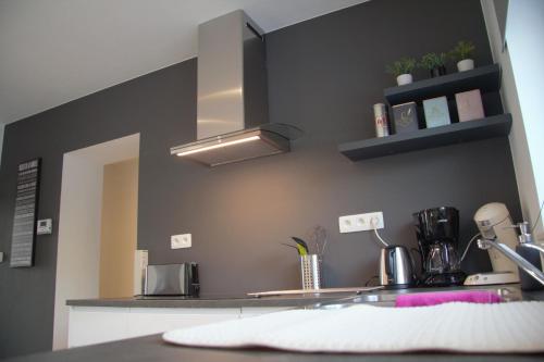 a kitchen with a sink and a counter top with aounter at Gîte du Lac in Fosses-La-Ville