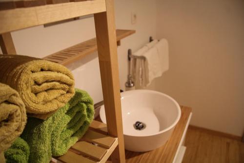 a bathroom with a sink and a towel at Gîte du Lac in Fosses-La-Ville