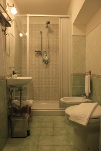 a bathroom with a sink and a toilet and a shower at Al Duomo Inn in Catania