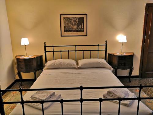 a bedroom with a large bed with two night stands at APPARTAMENTO Ruga Giuffa in Venice