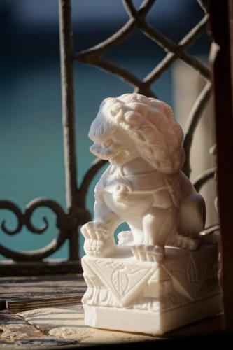 a white statue sitting on a table next to a fence at Granda Sweet Suites in Venice