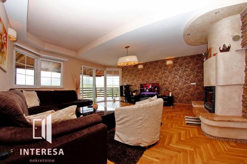 a living room with a couch and a fireplace at Vila Sani in Sarajevo