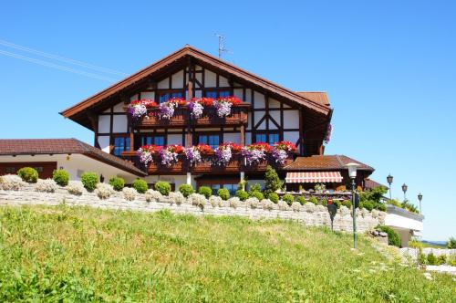 a house with flower boxes on the side of it at Gästehaus Alpenruh in Fischen
