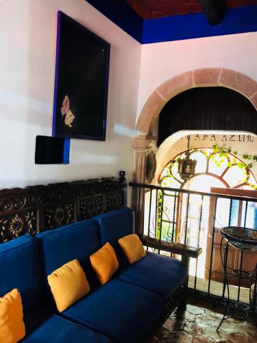 a blue couch in a living room with a fireplace at Casa Azul in Guanajuato