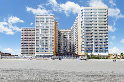 two tall buildings in front of a beach with condos at Sands Ocean Club in Myrtle Beach