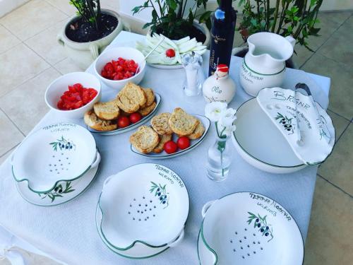 a table with plates and bowls of food on it at Dimora TerraNostra&Spa in Ugento