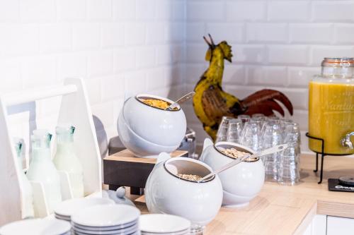 a table with bowls of food and a chicken in the background at Holiday Inn - the niu, Square Mannheim by IHG in Mannheim