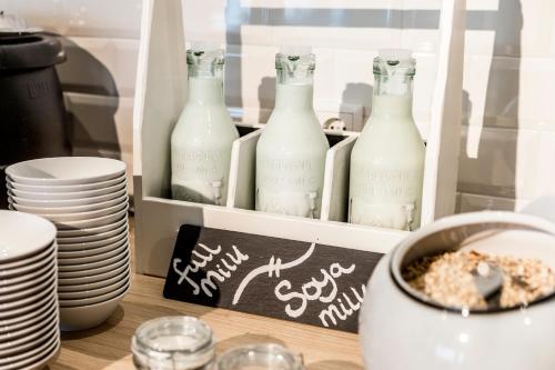 a shelf with bottles of milk on a table at Holiday Inn - the niu, Square Mannheim by IHG in Mannheim