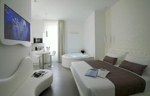 
a hotel room with two beds and a television at Mia Aparthotel in Milan

