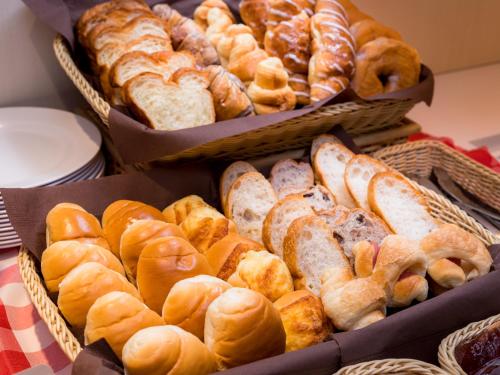 a bunch of different types of breads and pastries at Super Hotel Takamatsu Tamachi in Takamatsu