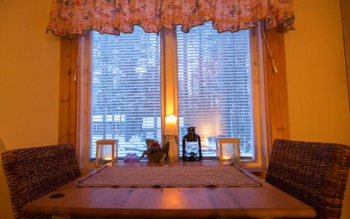 a table in front of a large window with a table sidx sidx sidx at Arctic Island - Remote island, reachable only by boat or snowmobile in Kurravaara