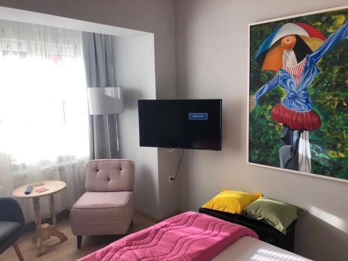 En tv och/eller ett underhållningssystem på ZeMoon Apartment