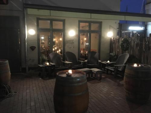 a room with chairs and barrels in front of a building at Seemannsheim Hostel Flensburg in Flensburg