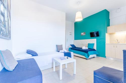 a living room with a bed and a couch at Pela Mare Hotel in Agia Pelagia