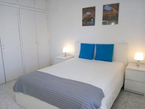 クアルテイラにあるTORRE 14 Vista Magnificaの白いベッドルーム(青い枕の大型ベッド付)