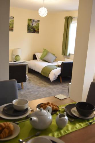 a room with a bed and a table with food on it at StayNEC Coach House Birmingham - For Company, Contractor & Leisure Stays - NEC, HS2, JLR, Airport in Birmingham