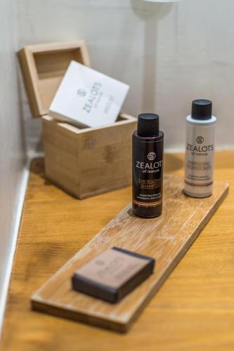 a table with a bottle of hair lotion and a box at Pela Mare Hotel in Agia Pelagia