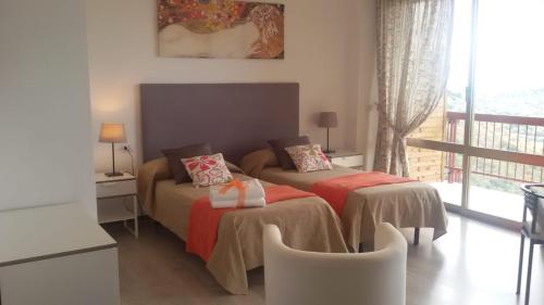 a bedroom with two beds and a balcony at Belvedere del Lago in Montefiascone