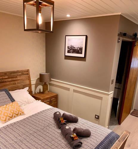 a bedroom with a bed and a picture on the wall at The Tower Arms Hotel in Iver