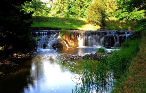 a waterfall in the middle of a river at Park Hotel Pruhonice in Pruhonice