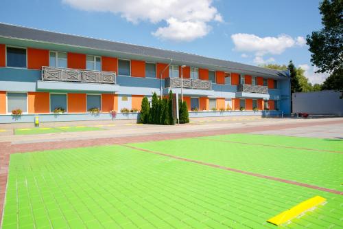 a building with a soccer field in front of it at Agro Complex Apartments in Nitra