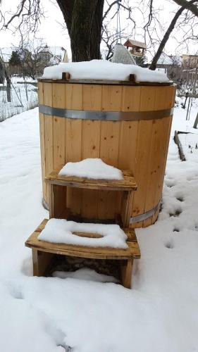 a wooden barrel with snow on top of it at SAUNA Dom in Pezinok