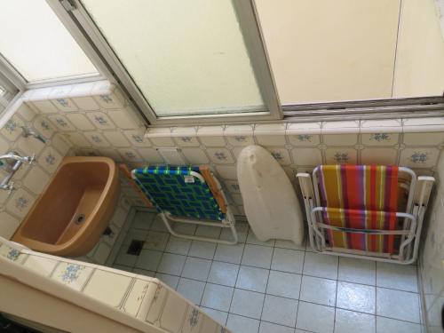 a bathroom with a sink and a toilet and a urinal at Seaside Miramar Apartment in Miramar