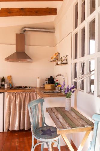 a kitchen with a table and chairs and a sink at Casa Rosalía in Ibi
