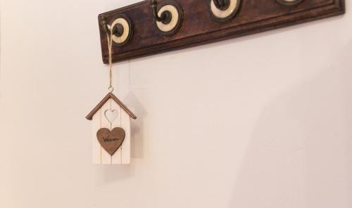 a wooden heart ornament hanging on a wall at Casa Rosalía in Ibi