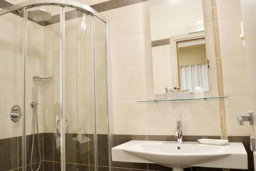 a bathroom with a sink and a shower at Hotel Tiffany in Marina di Massa