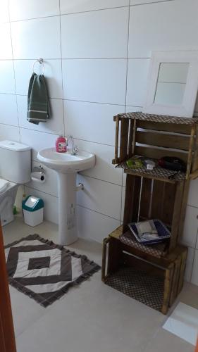 a small bathroom with a sink and a toilet at Apto Studio in Nova Petrópolis