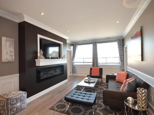 a living room with a couch and a fireplace at The SoMa Furnished Residences in Hamilton