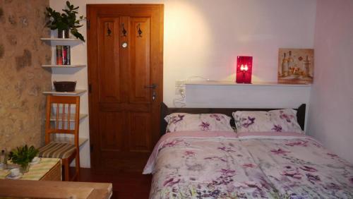 a bedroom with a bed with a red candle on it at Ferienhaus IL-PINO in Roccastrada