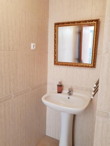 a bathroom with a sink and a mirror at A Casa Dos Amigos in Sesimbra