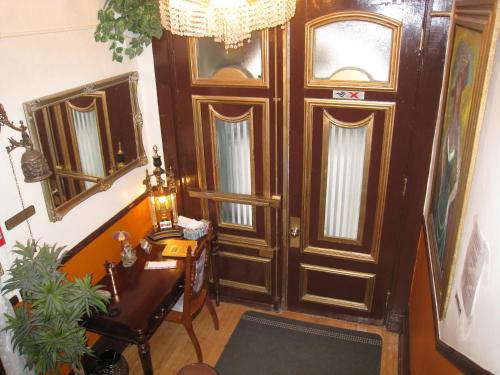 a room with a wooden door and a table and a desk at Castel d'Amérique Française in Quebec City