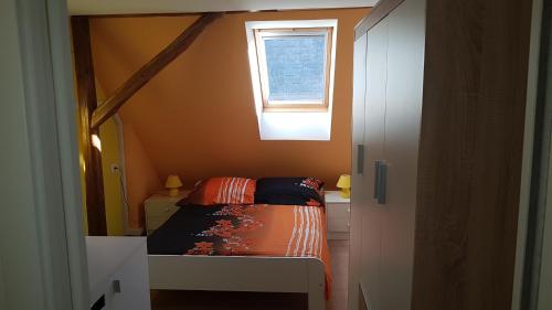 a small bedroom with a bed and a window at Apartma Pr Maruši in Bovec