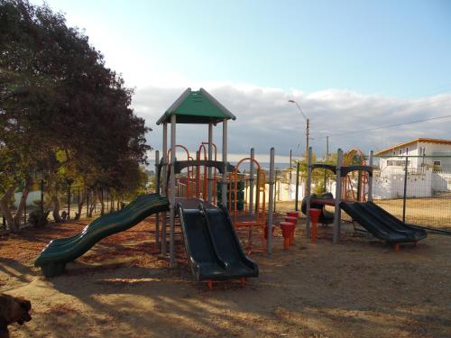 a playground with a bunch of slides at Cabañas Mirador de Soledad in El Quisco